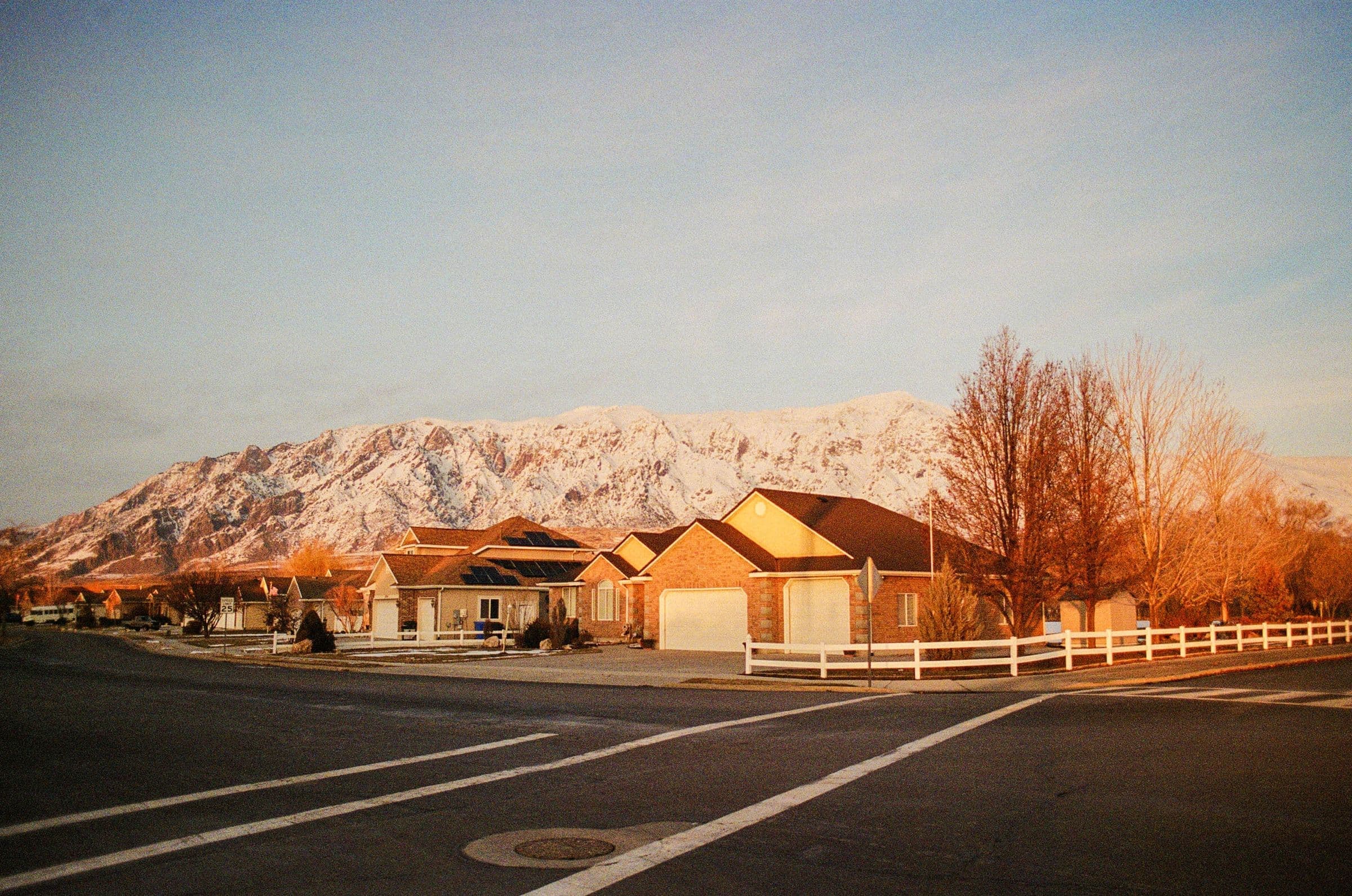 Row of homes at sunset with mountains behind them in Hayden